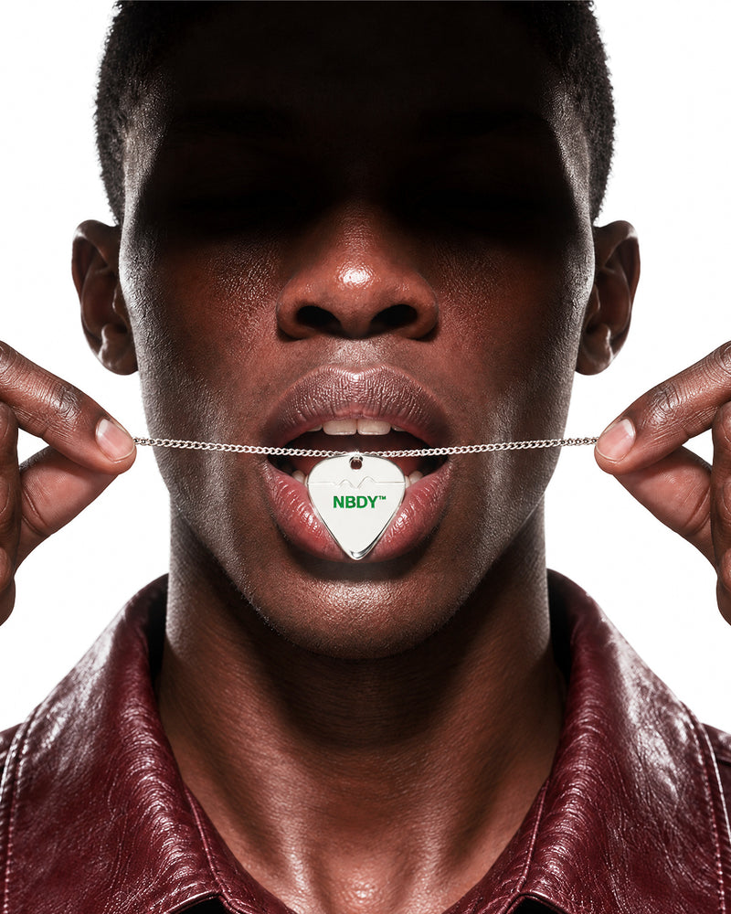 Model with a white NBDY pick on a chain in his mouth
